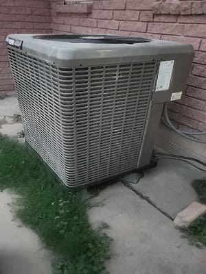 Outdoor air conditioning condenser beside a split-level home in Chubbuck, ID, inspected during a cold-weather walkthrough
