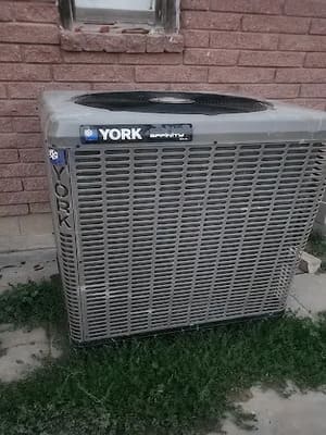 York AC condenser, residential install against brick